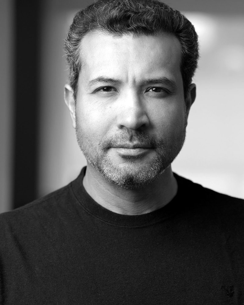 Ulrick Noel in a black T-shirt, black-and-white portrait